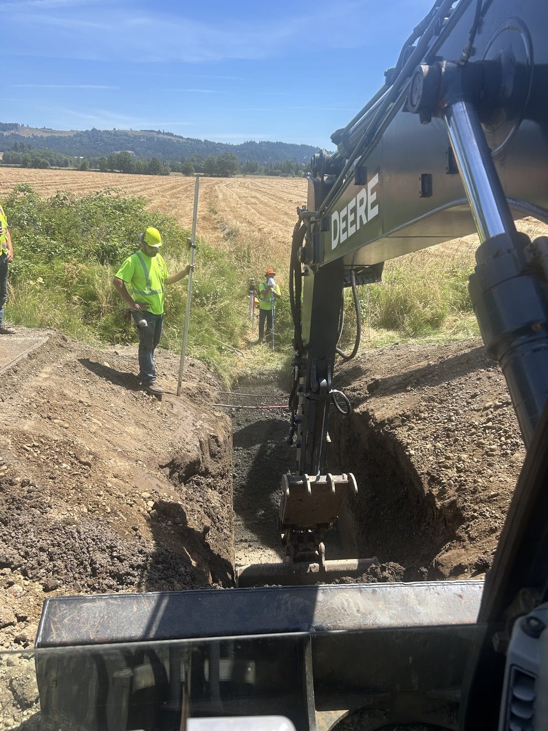 Crew installing a deep culvert to grade.